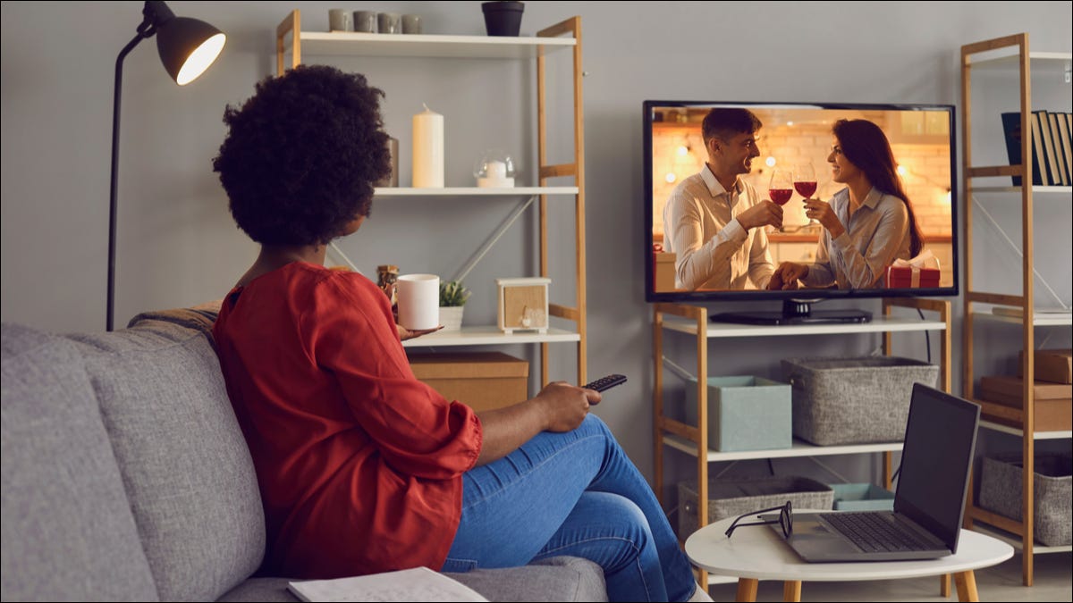 woman watching TV in living room