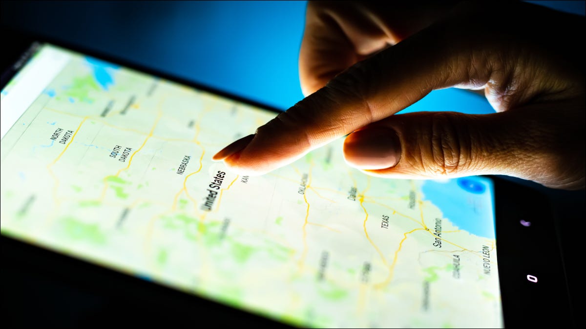 Primer plano del dedo de una persona tocando un mapa en la pantalla de una tableta.